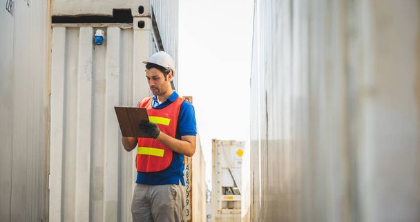 Foreman holding clipboard working at Container cargo harbor. Business Logistics import export shipping concept. - Foto, Bild