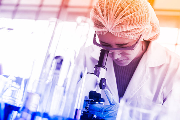 νέες γυναίκες επιστήμονες εργάζονται στην έρευνα και την ελεγχόμενη χημική ουσία με δοκιμαστικούς σωλήνες στο εργαστήριο. - Φωτογραφία, εικόνα