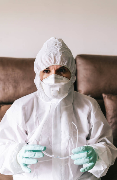 Portrait of protected woman with safety suit, glasses and mask before a pandemic or virus - 写真・画像