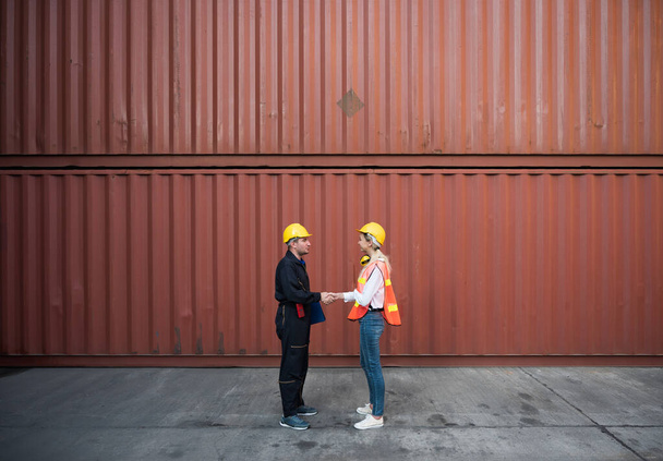 Happy dealing shaking hands two foreman man & woman worker working checking at Container cargo harbor to loading containers. Dock male and female staff business Logistics import export shipping concept. - Photo, Image