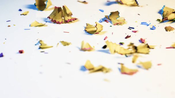 Randomly Sorted Golden View of Pencil's Shavings on a White Background .Pencil's Shavings Background on Selected Focus On Subject With Copy Space For Text . - Φωτογραφία, εικόνα