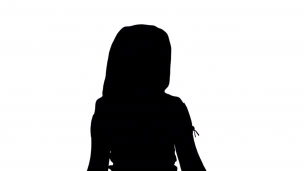 Silhouette Beautiful girl laughs and dances while walking. - Video