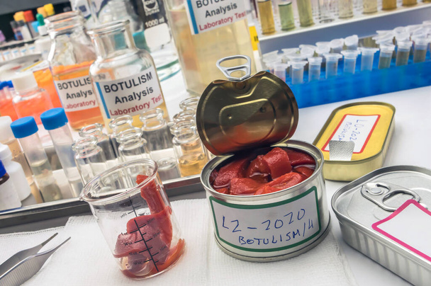 Experienced laboratory scientist analyzes red peppers from a canned food can to analyze botulism infection in sick people, conceptual image - Photo, Image