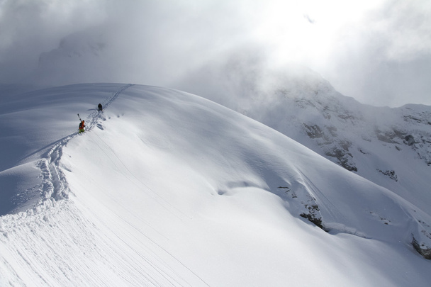 Skiers climbing a snowy mountain - Фото, зображення