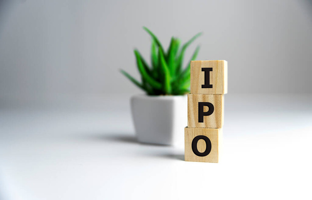 IPO - acronym from wooden blocks with letters, Initial Public Offering IPO concept, random letters around, white background. - 写真・画像