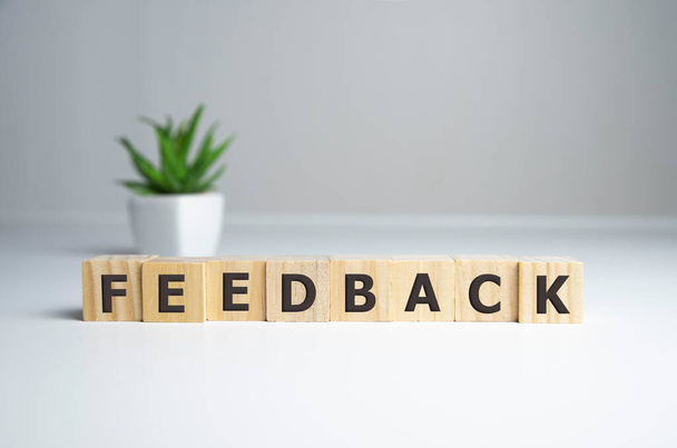 FEEDBACK word made with building blocks on white background - 写真・画像