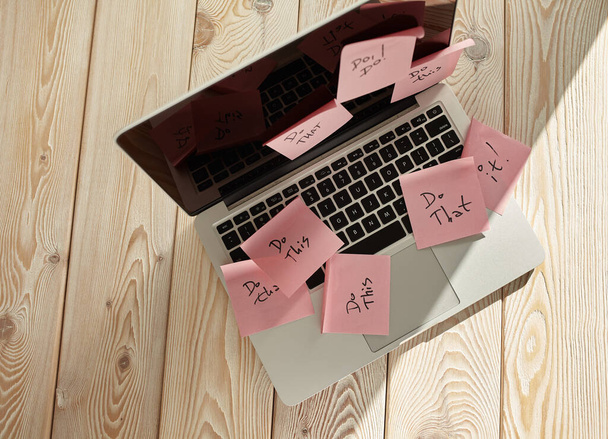 Image of laptop full of sticky notes reminders on screen. Work overload concept image. Coworking or working at home concept image. - Фото, изображение