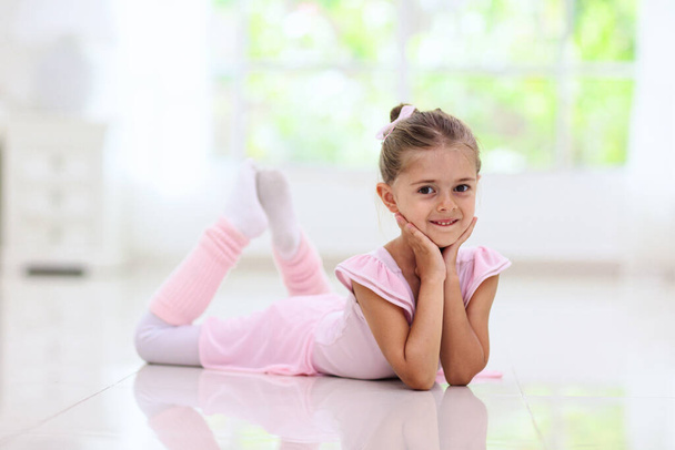 Ballet home training. Remote learning. Little ballerina in dance class. Cute girl in tutu and leotard learning to dance. Classic choreography for kids. Child dancer exercising. Online ballet course. - Fotó, kép