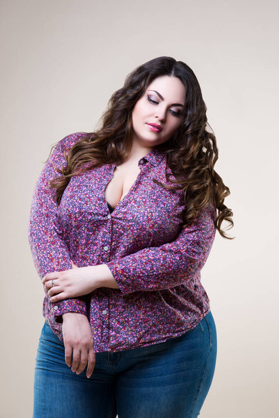 Sexy plus size model in casual clothes, fat woman on beige background, body positive concept - 写真・画像