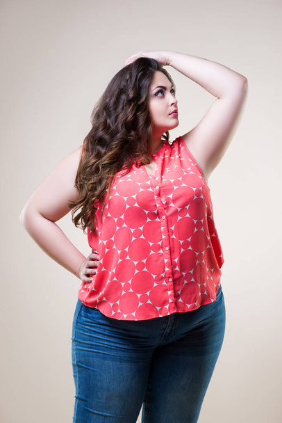 Plus size fashion model in casual clothes, cheerful fat woman on beige background, body positive concept - Foto, immagini