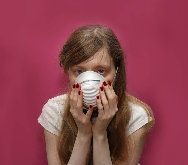 Young woman holding face mask without gloves as virus protection - Valokuva, kuva