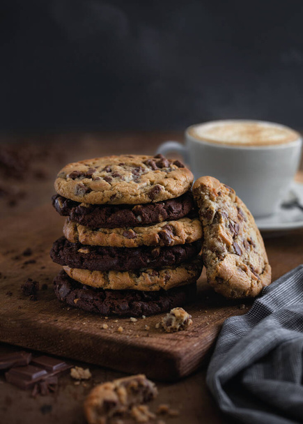 stack of chocolate and oatmeal cookies with a cup of coffee - Foto, Bild