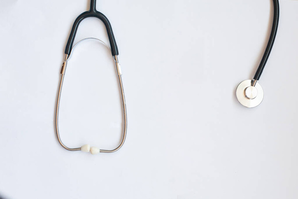 stethoscope and blue medical mask on a white background - Photo, Image