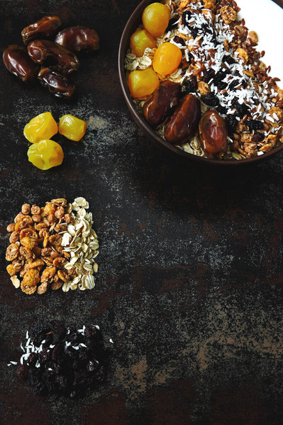 Healthy breakfast bowl of seeds, dates, dried fruit and granola. - Fotó, kép