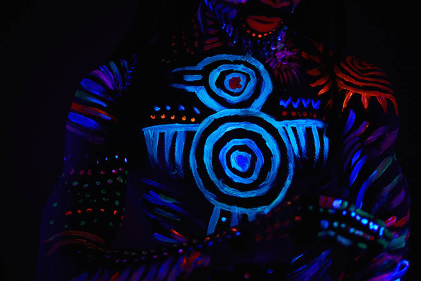 handsome african guy with fluorescent prints on chest and other parts of body - Foto, Bild