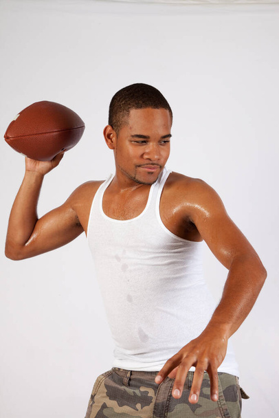 Handsome black man and an American Football - Fotó, kép