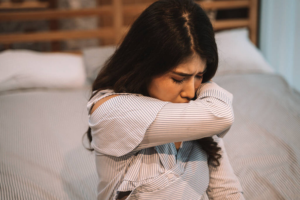 Portrait of 20s young Asian woman having dry cough in bedroom at home. Using elbow as a new normal to prevent pandamic covid-19 from spreading. Coronavirus new normal concept - Foto, Imagen