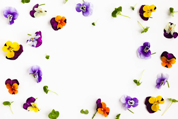 Spring or summer flower composition with edible pansy and micro greens on white background. Flat lay, copy space. Healthy life concept. - Foto, Imagen