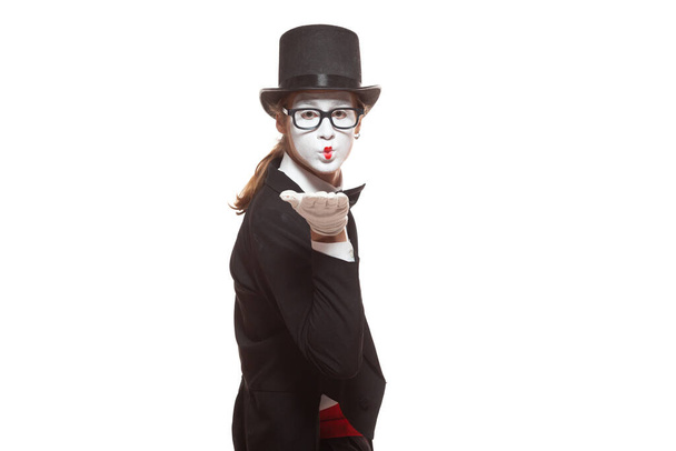 Portrait of male mime artist performing, isolated on white background. Mime blows a kiss. Symbol of sympathy, love, relationships - Valokuva, kuva