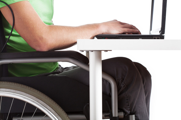 Disabled man sitting at a desk - Foto, Imagen