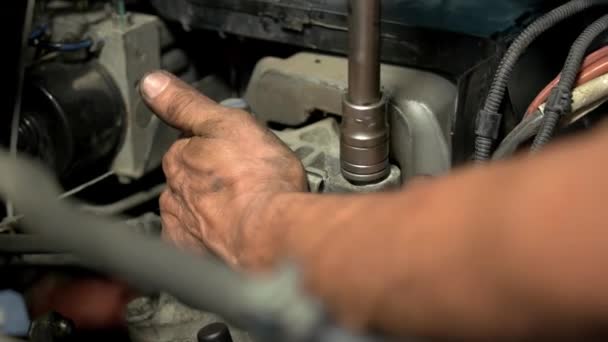 Close up tightly screwing a screw in a car engine. - Footage, Video