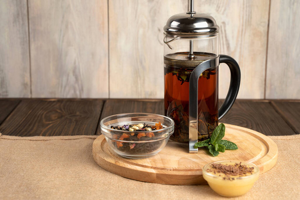 French press with fragrant tea and honey. - Photo, Image