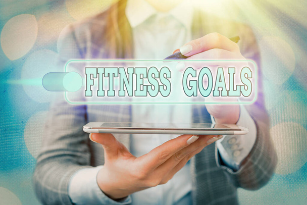 Handschriftlicher Text, der Fitness Goals schreibt. Konzept bedeutet Fettabbau Muskelaufbau Stärker werden Konditionierung. - Foto, Bild