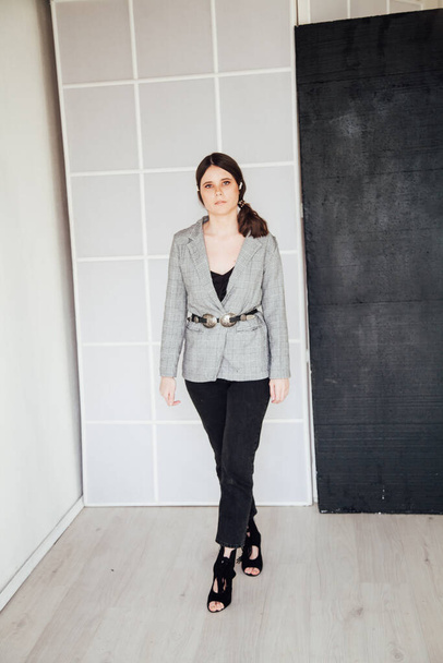 portrait of a beautiful fashionable woman in a business suit in the office - Photo, image