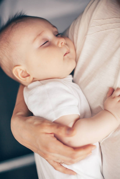 Close up portrait of beautiful baby boy sleeping in mother hands. Healthcare and medical love woman mothers day concept. Shallow DOF - Фото, зображення