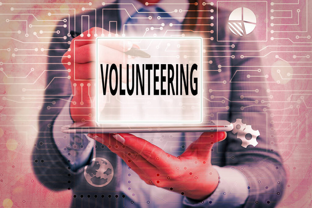Textschild mit der Aufschrift "Volunteering". Konzeptfoto Bereitstellen von Dienstleistungen ohne finanziellen Gewinn Bereitwillig verpflichten. - Foto, Bild