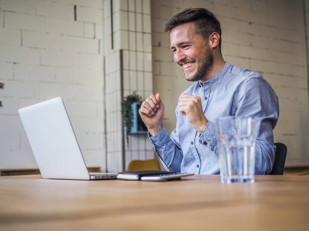 Mann in blauem Hemd mit Laptop in Coworking-Büro, Online-Fernarbeit und Quarantäne-Büro - Foto, Bild