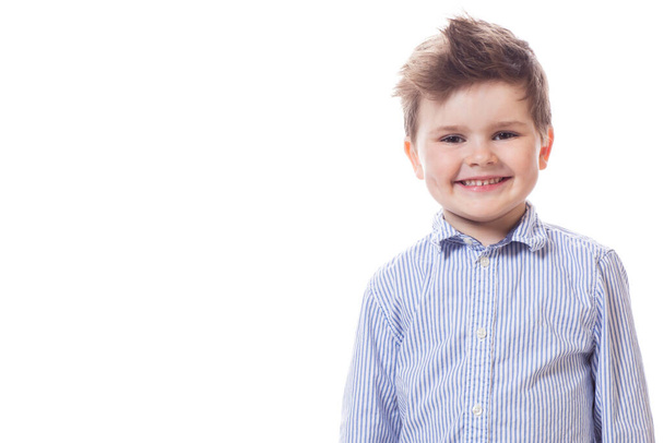 Young cute happy little boy possing on white background.  - Foto, afbeelding