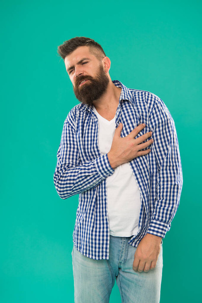 Care for your heart. Bearded man suffer from heart pain. Hipster hold hand on heart. Cardiovascular health. Healthy life. Heartache and chest pain. Healthcare. Preventing heart disease - Fotografie, Obrázek