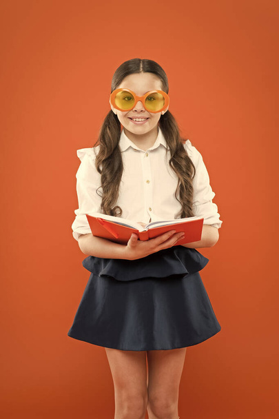 Study foreign language. Study literature. Pupil likes study. The more you know the more you grow. Small girl enjoying her school time. Happy little schoolgirl ready for lesson. Cute child with book - Photo, Image