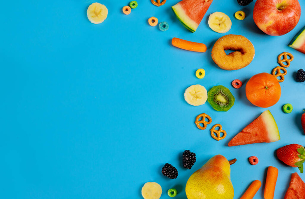 Assortment fresh fruits and vegetables on blue background. Healty food concept. - Fotografie, Obrázek