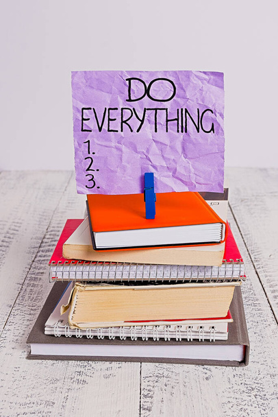 Handwriting text Do Everything. Concept meaning Jack of All Trades Self Esteem Ego Pride No Limits pile stacked books notebook pin clothespin colored reminder white wooden. - Photo, Image