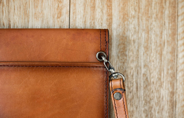 Close up brown leather wallet on wood texture. - Фото, зображення