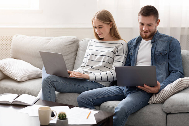 Young couple studying and playing video games on laptops - Photo, Image