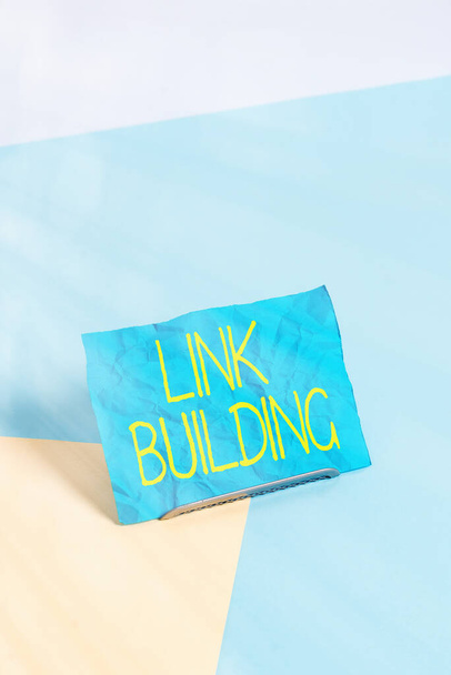 Conceptual hand writing showing Link Building. Business photo showcasing SEO Term Exchange Links Acquire Hyperlinks Indexed Paper on buffer wire on soft pastel multi colours backdrop. - Photo, Image
