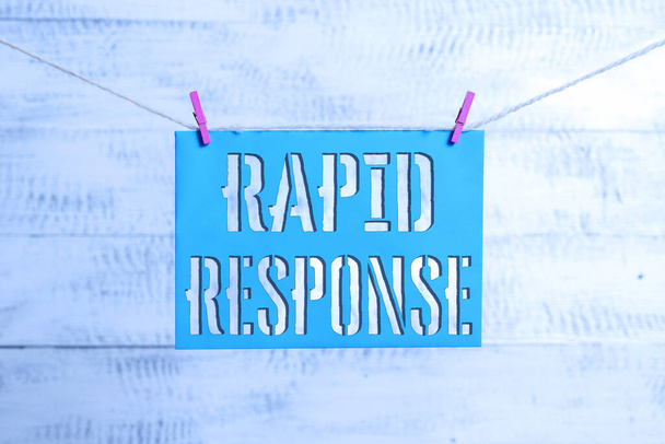 Schriftzug Rapid Response. Konzept bedeutet Medical Emergency Team Schnelle Hilfe im Katastrophenfall Wäscheleine Wäscheklammer rechteckige Papiererinnerung weißes Holz Schreibtisch. - Foto, Bild