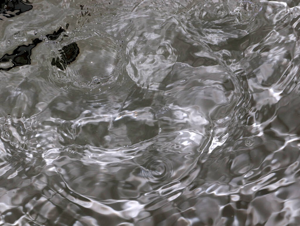 splashes and waves on the surface a rapid flow of clean boiling water - Photo, Image