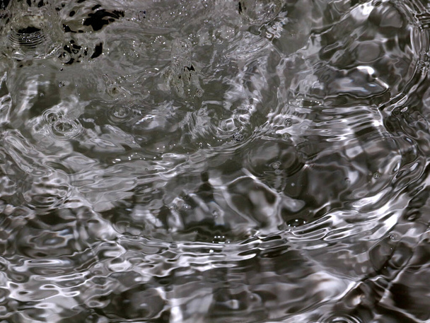 splashes and waves on the surface a rapid flow of clean boiling water - Φωτογραφία, εικόνα