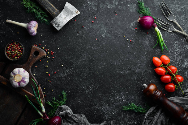 Black kitchen banner: vegetables and spices on a black stone background. Top view. - Fotoğraf, Görsel