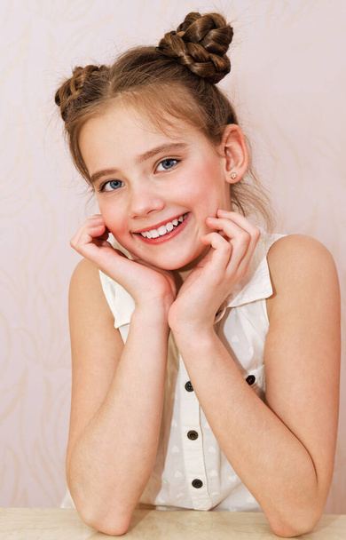 Portrait of adorable smiling little girl child preteen isolated. Dental concept  - Foto, afbeelding