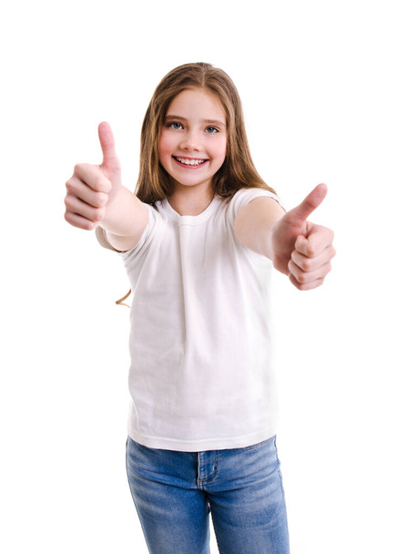 Portrait of adorable smiling little girl child in jeans and white t-shirt with two fingers up isolated on a white background - Photo, Image