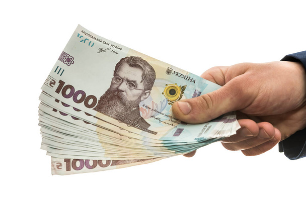 Geschäftsmann besticht oder bezahlt, isoliert. UAH. 1000 neue Banknoten ukrainisches Geld - Foto, Bild