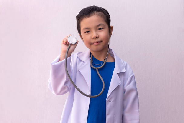 Asian girl playing doctor with stethoscope in hands.  - Photo, Image