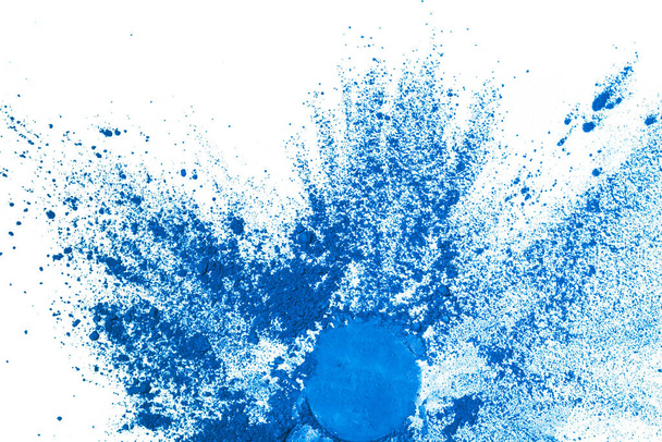 Splash of blue colored pigment powder. Blue powder particles splatter on white blackground. - Photo, Image