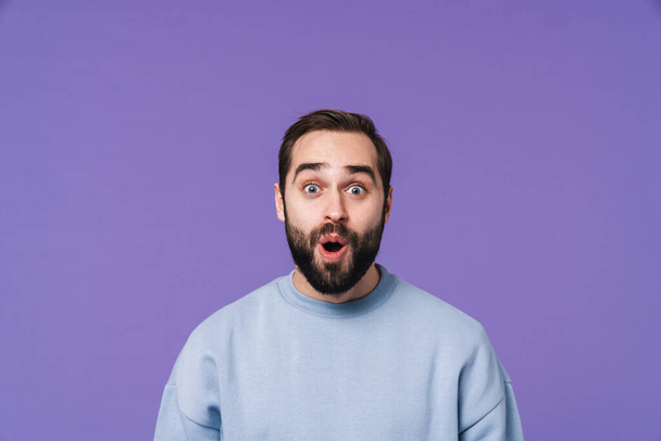 Image of a shocked surprised handsome young man isolated over purple background. - Fotografie, Obrázek