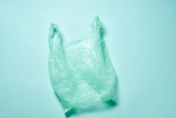 Empty plastic green bag over green background - Photo, image